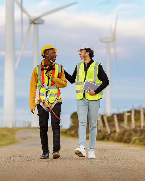 engineers walking through wind turbine park